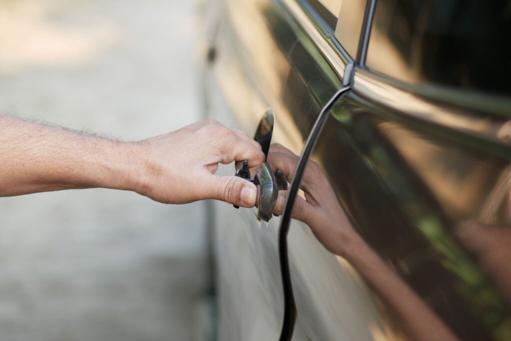 men hand open a car door